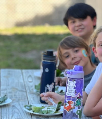 students enjoy school meal outside